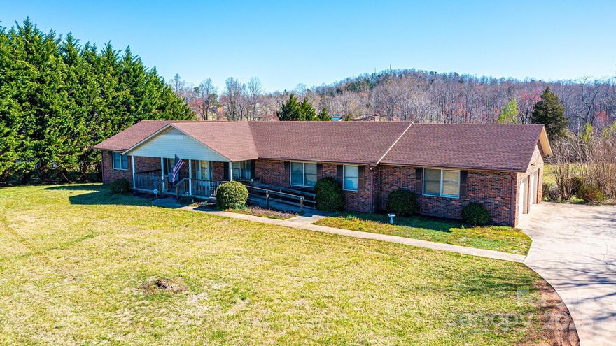 Spacious Brick Ranch Home with Business Zoning. This expansive 2,400 sq. ft. brick ranch-style home features a finished 1,300 sq. ft. basement, complete with a kitchen and half bath. With 4 bedrooms and 4 baths, this home offers ample space for comfortable living. The main level includes a 2 car garage, while the lower level provides an additional garage bay with its own garage door. The interior boasts a large kitchen and dining room, along with a  0.98-acre lot with 200 feet of street frontage, this home provides plenty of outdoor space, including a concrete patio in the backyard and a covered front porch with a ramp for easy access. A spacious driveway ensures ample parking, convenient for residential or business use. Zoned for business and currently operating as a licensed assisted living facility, this property offers a unique opportunity for investment or multi-use purposes. This home is located 27 minutes to Hickory, 22 Minutes to Morganton, and 32 minutes to Blowing Rock.