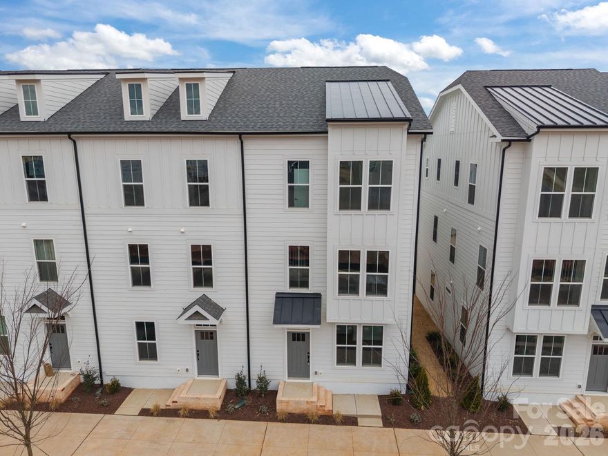 Welcome to The River District—a true master-planned community designed for the way you live, work, and play.

This beautifully appointed Landon three-story townhome offers exceptional flexibility and style. The main level features a spacious flex room—perfect for a home office, game room, gym, or creative studio.

Upstairs, the heart of the home shines with a gourmet kitchen showcasing quartz countertops, a built-in oven and microwave, electric cooktop, and soft-close cabinetry. The open-concept dining and living areas provide an inviting space for entertaining, with sliding glass doors leading to your private balcony—ideal for morning coffee or evening relaxation.

The third level hosts a serene owner’s retreat, complete with a bright and airy bedroom and a spa-inspired bath designed for ultimate comfort. Two additional bedrooms, a full bath, and a conveniently located laundry area complete the upper floor.

Every detail of this home has been thoughtfully curated, with interior design finishes individually hand-selected by our professional design team.

Location truly sets this home apart. At The River District, you’re just minutes from everything you need. The community will feature resort-style amenities including a pool, clubhouse with fitness center, tennis and pickleball courts, parks, scenic trails, a working two-acre farm with an on-site farmer, and a stunning riverfront amphitheater.

Experience elevated living in a vibrant community where convenience meets connection.