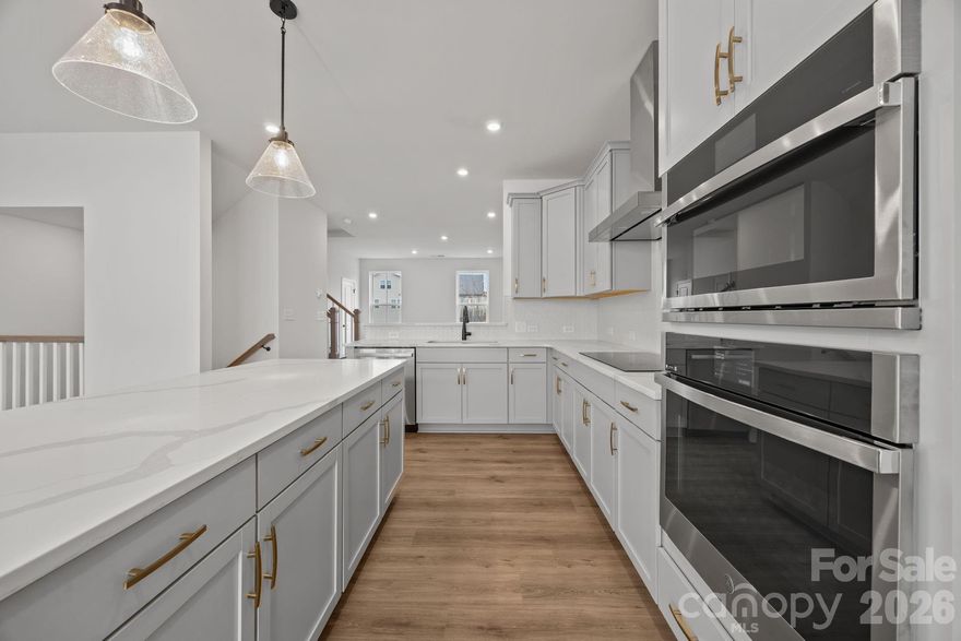 Welcome to The River District—a true master-planned community designed for the way you live, work, and play.

This beautifully appointed Landon three-story townhome offers exceptional flexibility and style. The main level features a spacious flex room—perfect for a home office, game room, gym, or creative studio.

Upstairs, the heart of the home shines with a gourmet kitchen showcasing quartz countertops, a built-in oven and microwave, electric cooktop, and soft-close cabinetry. The open-concept dining and living areas provide an inviting space for entertaining, with sliding glass doors leading to your private balcony—ideal for morning coffee or evening relaxation.

The third level hosts a serene owner’s retreat, complete with a bright and airy bedroom and a spa-inspired bath designed for ultimate comfort. Two additional bedrooms, a full bath, and a conveniently located laundry area complete the upper floor.

Every detail of this home has been thoughtfully curated, with interior design finishes individually hand-selected by our professional design team.

Location truly sets this home apart. At The River District, you’re just minutes from everything you need. The community will feature resort-style amenities including a pool, clubhouse with fitness center, tennis and pickleball courts, parks, scenic trails, a working two-acre farm with an on-site farmer, and a stunning riverfront amphitheater.

Experience elevated living in a vibrant community where convenience meets connection.