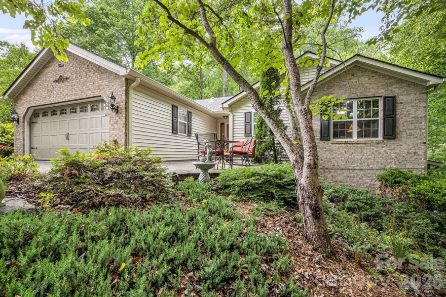 Nestled in the highly desirable Etowah’s Reach community, this spacious home offers a perfect blend of elegance, natural beauty and a cul de sac setting. The park-like backyard is a private, wooded sanctuary featuring a serene babbling creek and an inviting fire pit area. Inside, the main level boasts a sun-drenched, heated sunroom and an expansive 300-square-foot screened porch complete with a hot tub (negotiable). The chef's kitchen features granite countertops, a center island, a breakfast bar, and a gas stove, flowing seamlessly into a Great Room highlighted by skylights and a cozy gas fireplace. The main floor includes two bedrooms and two full baths. The fully finished, walk-out lower level serves as an ideal in-law suite or guest quarters, complete with a large bedroom, full bath, spacious family room, a workshop area, and a pub room with a second gas fireplace. Residents enjoy premier community amenities including a pool, tennis and pickleball courts, and regular social events, all just minutes from golf, shopping, regional airports, and Pisgah National Forest with hiking and fishing.