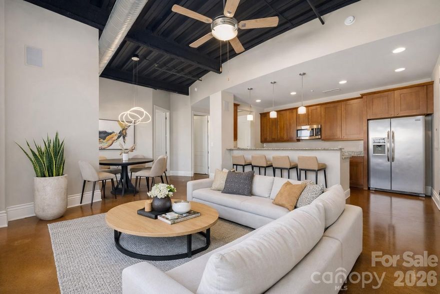 Live where Charlotte comes alive. This industrial-modern condo in the heart of NoDa blends style, space, and unbeatable walkability. Featuring 10-ft ceilings, exposed concrete floors, and an open, sun-filled layout, the home feels airy and effortlessly cool—perfect for both entertaining and everyday living.

The open kitchen shines with granite countertops, stainless steel appliances, generous storage, and bar seating ideal for hosting. Two bedrooms and two full baths offer flexibility for work-from-home, guests, or roommates.

Step outside to two private balconies and take in Uptown Charlotte views—perfect for morning coffee or evening cocktails. Residents also enjoy a 5th-floor rooftop terrace with stunning skyline views and nearby pet-friendly green spaces.

Located just steps from NoDa’s popular bars, restaurants, breweries, and art galleries, with quick access to Villa Heights, Plaza Midwood, South End, and Uptown via the light rail, this home delivers true urban convenience.

HOA includes water and sewer. All appliances convey. HVAC replaced in 2024.
Stylish, walkable, and move-in ready—this is city living done right.