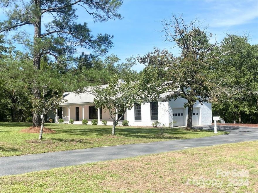 Rare find! Beautiful ALL BRICK RANCH home nestled on 2 acres.. Country living at its best with many updates & modern finishes thoughout. You will be greeted by the 42' covered rocking chair front porch perfect for morning coffee. Gleaming hardwood floors frame the living room that flows into the archways dining room. Every Chef's dream kitchen w/ breakfast area, pantry & plenty of counter & cabinet space. New LVP flooring ,granite, stainless steel smooth surface range, dishwasher, microwave and side by side frig. The family room offers new LVP floors, built-ins & access to 200 sq ft screen porch w/panoramic views of the wooded backyard. The primary ensuite features 2 closets, new shaker vanity, quartz counters and New LVP floors. Oversized hallway bathroom features new shaker cabinets w/ quartz counters & dual sinks. 2 car garage w/ utility room /laundry area. Nice level land with plenty of room to build your dream shop, gardening or park your RV/trailers.  Fireplace sold "AS IS".