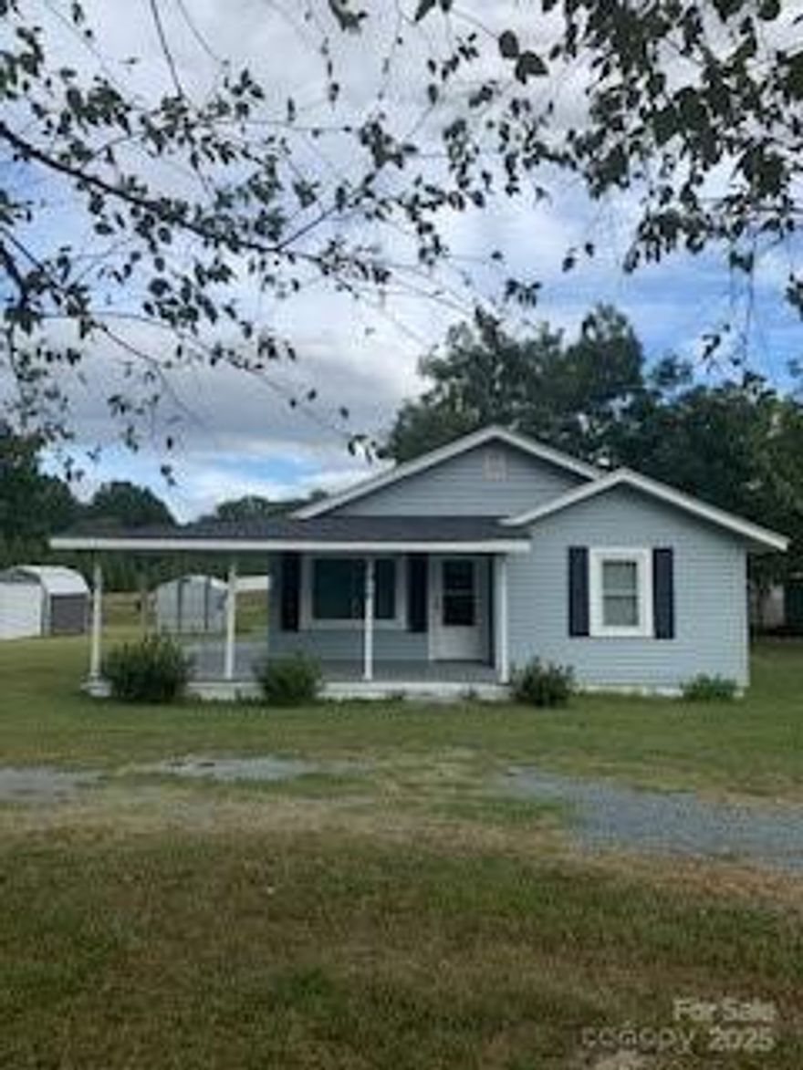 Large sunny open lot with cute bungelow and circular driveway. Relax on the front porch and adjoining side porch. Hardwood floors, large - eat-in kitchen, nice size bedrooms.  This home has a quaint vintage feel with some updates.  Home is being pre-inspected and report will be available to buyers.  Home is being sold 'as is' and is surrounded with newer homes.  Has great curb appeal.  Close to shopping, and Hwy 74.  Come see this cute home.