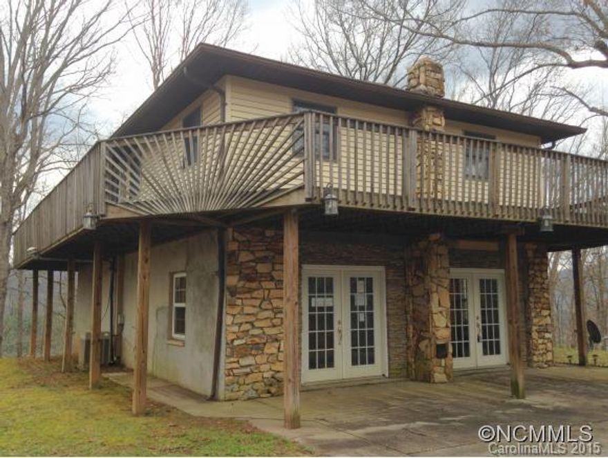 Whittier, NC. Private home with an amazing winter view! House sits on 6+ acres and slopes down to the Tuckasegee River. Fantastic deck that wraps around the entire main level. Upstairs has 2 beds and 1 bath with extra room that could be used as a den or sun room. Lower level has living area/rec-room with a place for wood stove, bonus room and bath. Great deal with amazing potential!