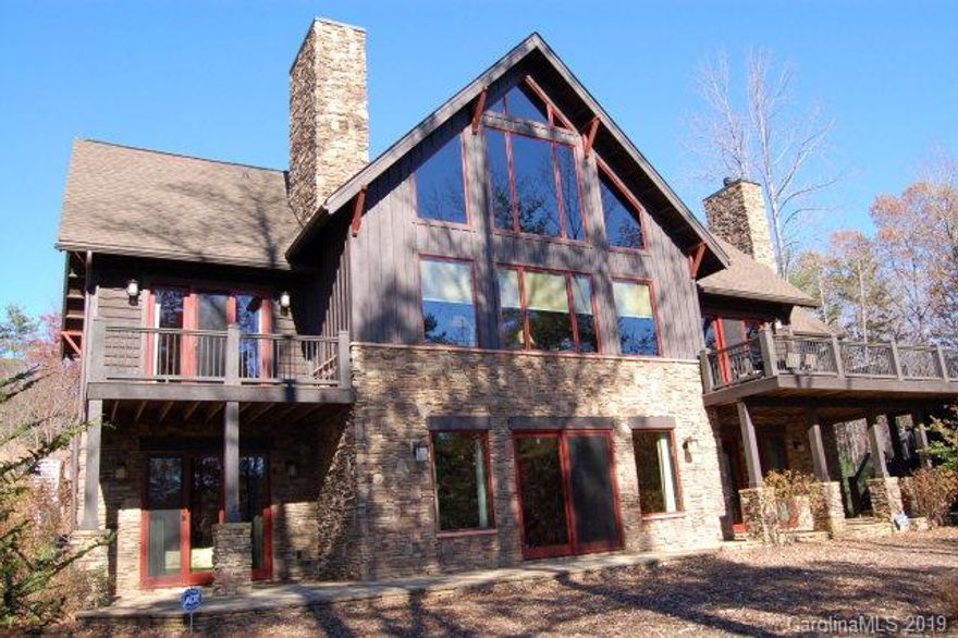 You cant choose your family, but in this beautiful Lake James lodge, you can bring them along and also get away from them. Walk into this home and youll immediately notice the spacious comfort, cathedral ceiling, and 3 mile view through the wall of windows. The huge den, finely appointed kitchen, utility room, and of course the master suite are all located on this main floor. Turn around and check out the loft with 2 bunkrooms designed for sleeping a crowd and an open office area. Follow the stairs down and youll find 2 more bedrooms and bathrooms centered by another large family gathering area.The rustic elegance of this home also includes distressed elm floors, a stone patio, outdoor shower, fire pit, and a full house/dock sound system.  Membership to Camp Lake James included.