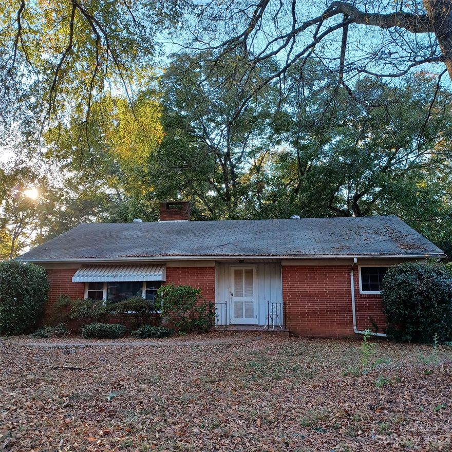 Great Location with Quick access to I-485 and I-85, Billy Graham Parkway. Updated Mid-century Modern Brick 3 BR Ranch with many Cool features like Built in Bookshelves, Solid Masonry Wood Burning Fireplace, Oak Harwood Floors, Central AC and Heat, Insulated Double Pane Windows, Kitchen with new Countertops, New Sink and Corresponding High Neck Faucet, Appliances include Disposal, Dishwasher, Refrigerator, Range and Oven, Laundry room features Convenient Side Lavatory. Rear Porch Features 2 Exterior doors, one to Private Patio Area and second convenient to Driveway.  Extra Large Half Acre Lot includes Fenced Rear Yard, Picnic Area with table and Firepit Area, Only One Utility All Electric Home has Well and Septic Tank which means NO City Water/Sewer and Natural Gas Expense. Wilson STEM Academy is merely walking distance, Jackson Day School (Charter) 7 min, 200 Acre Robert L Smith Park is 4 minutes away.  Major Grocery Store and Restaurants less than a mile away, 3 minutes.