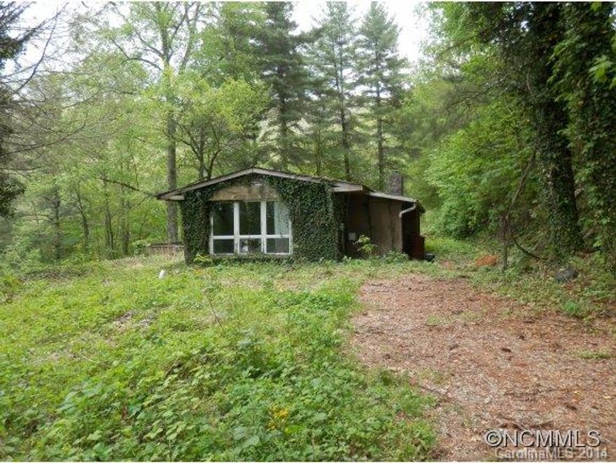 Wonderful improved 1 acre plus lot with old rock and frame house with no value. Beautiful double rock retaining wall and nice rock work on fireplace. House is open. Easy driveway.  Can't find a well,  it's possibly on a spring.