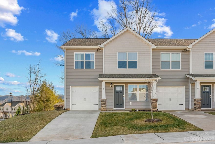 Discover the perfect blend of comfort, convenience, and scenic beauty in this 3-bedroom, 2.5-bath end unit townhome. Ideally located near Hwy 26, just a short 10-minute drive from the heart of Asheville, this home offers the best of both worlds – proximity to the city and the tranquility of long-range mountain views. The heart of this home is situated in the main first-floor living area which boasts warm Mohawk RevWood floors in the living area, a stylish kitchen featuring granite counters, shaker style cabinets, a tasteful tile backsplash, and stainless-steel appliances. With an attached 1-car garage and a spacious laundry room, this townhome prioritizes convenience and functionality. The programmable smart home package adds a modern touch, providing you with seamless control over your living environment. Enjoy the luxury of having yard and exterior maintenance covered by the association, allowing you to focus on the things that matter most. Don't miss this great townhome property!
