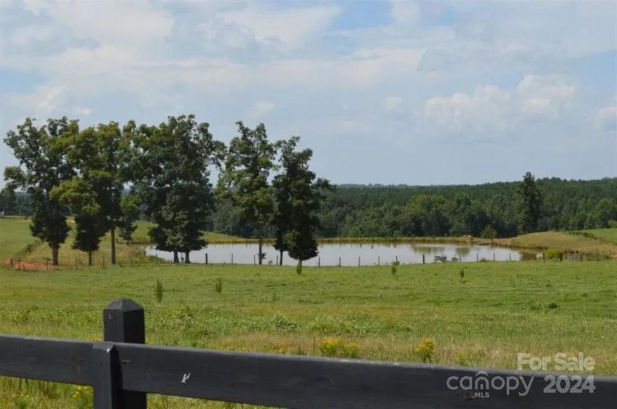99.5+- acres that is fenced, cross-fenced, and ready for your cattle operation. Four ponds fed by a year round spring and flowing creek provide ample water sources. Nice wooden fence with custom gate along the road and driveway plus equipment barns and sheds. There is a home on the property that is livable as well.