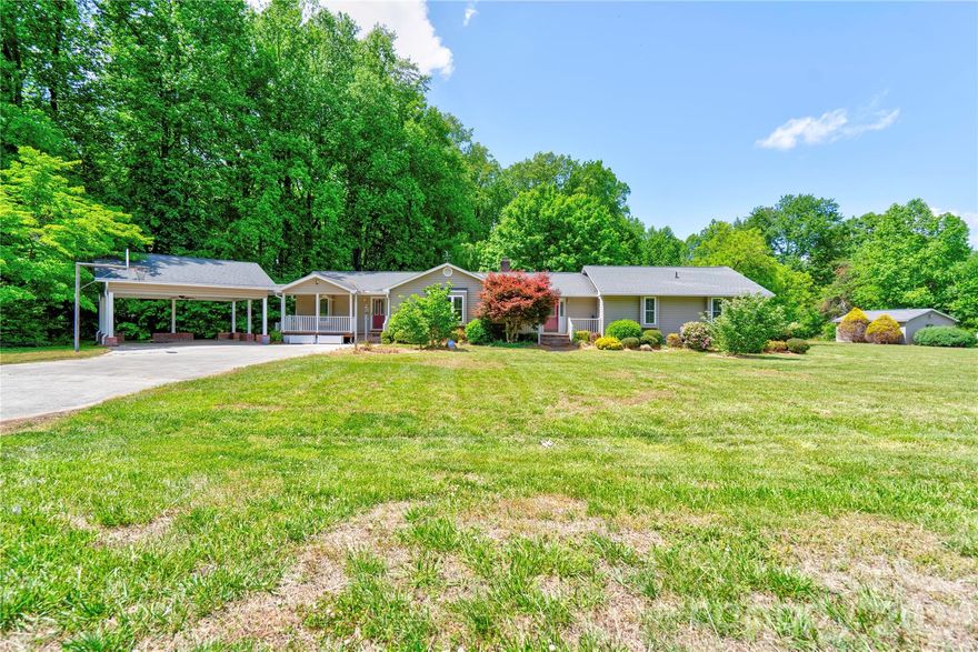 Welcome to this 3-bedroom home nestled on 1.97 acres, situated on a level lot and offering the perfect blend of comfort and space! Step inside to find new LVP flooring throughout the main living areas and fresh carpet in all bedrooms, creating a warm and inviting feel. Most of the home has been freshly painted, including the kitchen cabinets, giving it a bright, updated look.  The updated kitchen features beautiful granite countertops and provides a great space for cooking and gathering. Enjoy year-round relaxation in the sunroom overlooking the expansive rear yard.  This home also offers plenty of interior storage, giving you the space you need to stay organized. Recent updates include a new hot water heater for added peace of mind.  Outside, you’ll love the covered front porch, perfect for rocking chairs, and the concrete rear patio.  The property also includes a storage building and a detached double carport, offering even more storage and parking options.  With nearly 2 acres to enjoy, this property offers privacy, room to roam, and endless possibilities!