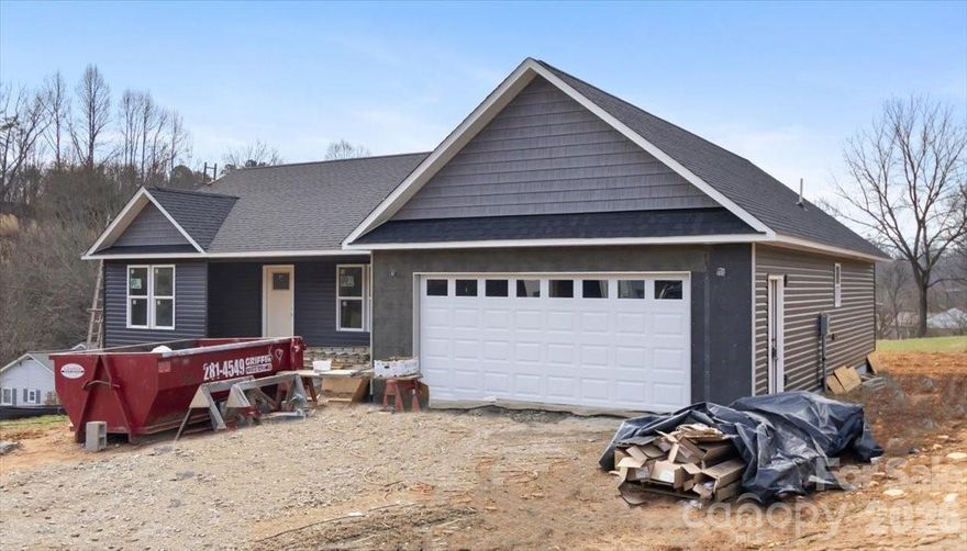 Welcome to peaceful mountain living in the heart of the Appalachian Mountains in beautiful Madison County, just outside Mars Hill. This brand new 3 bedroom, 2 bath home offers easy main level living with a thoughtfully designed open, split bedroom floor plan. Quality craftsmanship shines throughout, featuring granite countertops, stainless steel appliances, tasteful lighting fixtures, cathedral ceilings, and a spacious double car garage, all situated on a full one acre lot. Located in the new Bailey’s Cove Road community just off Highway 213 & Bone Camp Rd., you’ll enjoy both privacy and convenience. Nearby Mars Hill is home to the Southern Appalachian Repertory Theatre and Mars Hill University. You’re also just a short drive to Marshall, Hot Springs, Weaverville, Asheville, Burnsville, and Johnson City. Outdoor enthusiasts will love all that Madison County has to offer, from hiking and horseback riding to whitewater rafting, kayaking, and fishing along the scenic French Broad River. Winter fun awaits just minutes away at Hatley Pointe Boutique Ski Resort. One of the first of 10 homes planned for this charming new neighborhood, an exceptional opportunity to enjoy mountain living at its finest.  No HOA, No Dues, estimated completion toward the end of April.