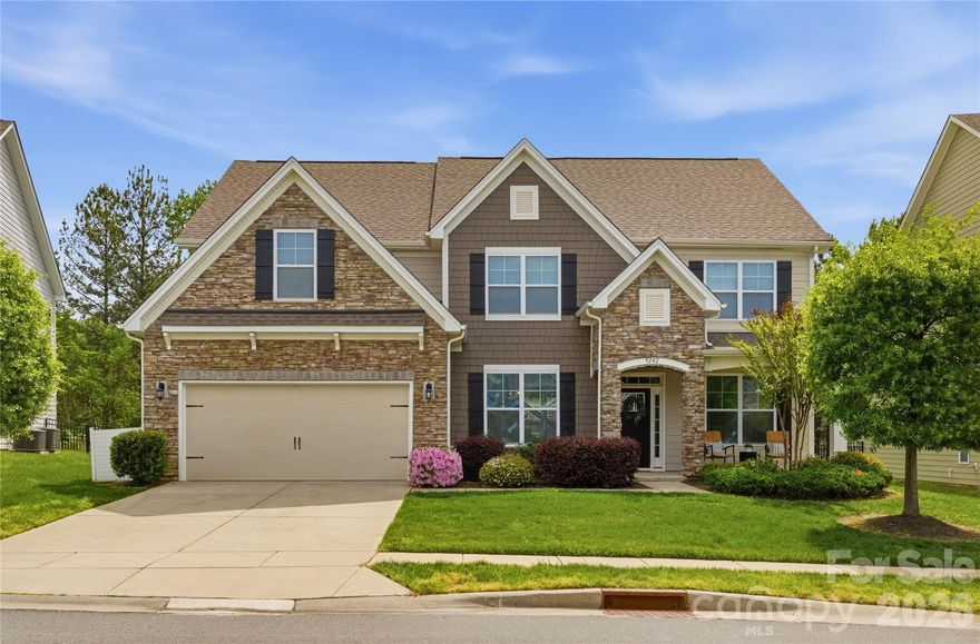 Welcome to 9242 Vecchio Drive, where elevated design meets everyday functionality in one of Indian Land’s most desirable amenity-rich communities—just minutes from Ballantyne with the added benefit of low Lancaster County taxes. This thoughtfully designed Washington plan offers five spacious bedrooms and a layout tailored for the way you live today. From the moment you step inside, you’re greeted by beautiful hardwoods that flow throughout the main living areas and up the staircase, setting the tone for a home that feels both refined and inviting. Brand new carpet throughout adds a fresh, move-in ready feel and enhances the home’s comfort from top to bottom.
The heart of the home is a true chef’s kitchen, complete with double ovens, a gas cooktop, an expansive walk-in pantry, and seamless flow into the main living and dining spaces—perfect for hosting everything from casual weeknight dinners to larger gatherings. Just off the side entry, a functional mudroom keeps everyday life organized and out of sight. Designed with flexibility in mind, the main level features a private guest suite with a full bath—ideal for visitors or multi-generational living—as well as a dedicated home office, offering the perfect space to work remotely in comfort and style. Upstairs, the spacious primary suite is a serene retreat, featuring a luxurious en-suite bathroom with dual vanities, a soaking tub, a walk-in shower, and a large walk-in closet. You will also find generously sized secondary bedrooms and an added bonus room, creating the perfect retreat for movie nights, a playroom, or a secondary living space tailored to your needs. Set on a wooded homesite, the outdoor experience offers both privacy and tranquility, while the irrigated lawn ensures easy maintenance and year-round curb appeal. Beyond the home, residents enjoy access to a vibrant community filled with exceptional amenities, such as an outdoor pool, club house, fitness center, playground, and recreational areas, creating opportunities to relax, connect, and enjoy an active lifestyle right outside your door. This beautifully maintained home that blends thoughtful design, comfort, and location is ready to welcome its next owner.