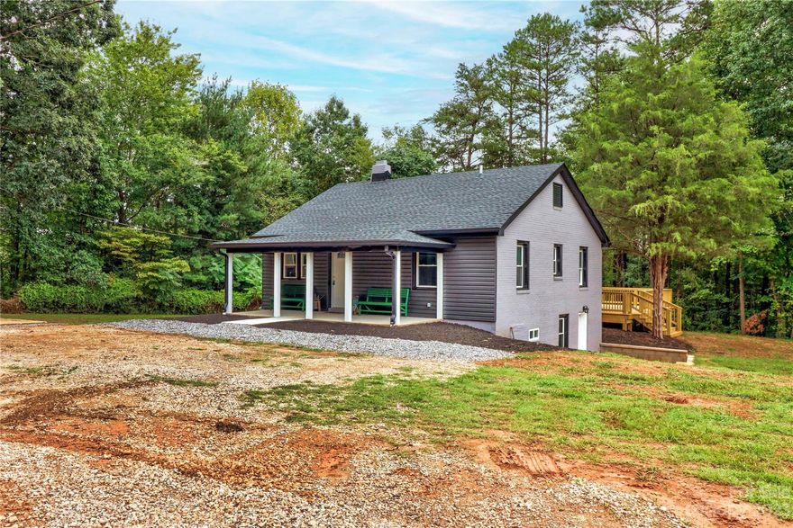 Looking for privacy? Surrounded by beautiful woods?.64 AC. Then check out this beautiful 2 bedroom 2 full bath home .This home has many updates. Awesome chef's kitchen offers beautiful granite countertops, loads of new kitchen cabinets & all SS appliances. Absolutely perfect to whip up all your favorite holiday meals. Roof approx. 4 years old according to previous owner. Beautiful brick fireplace w/ amazing large hearth in large living room. Perfect for entertaining or just enjoying a cozy winter night with your loved ones. Home has a super large wrap around deck to kick back & unwind from a busy day's work or cook out with friends & family. Large covered front porch. This home is surrounded with beautiful woods & abundant nature all around. Unfinished basement with updated lighting offers wonderful storage or perfect man cave. Additional 1.97 acre lot is also available. See MLS 4065617 & MLS #4065611.Seller has applied for rezoning from B-5 to Residential Zoning.