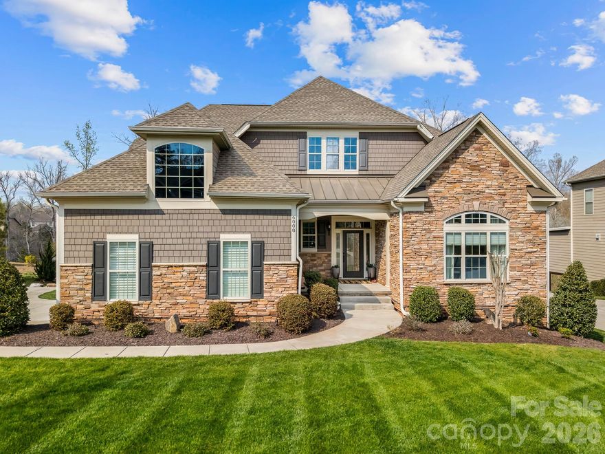 Stunning, meticulously maintained luxury home just 8 minutes from downtown Waxhaw, perfectly positioned on a premium cul-de-sac lot backing to private wooded views in the sought-after Toll Brothers Executive Section of the Bent Creek community.
This designer-upgraded home offers a refined blend of elegance and functionality, featuring a primary suite on the main level, along with an additional bright bedroom and full bath, a dedicated home office with built-ins, and flexible living spaces throughout. The home feels elegant and welcoming from the moment you enter. The primary retreat includes a custom walk-in closet and a beautifully appointed bath with a spacious walk-in shower and bench.
The chef’s kitchen showcases a large granite island, gas cooktop, generous pantry, and abundant natural light, all opening seamlessly to the main living area, creating an inviting space for both everyday living and entertaining. Designer window treatments and elevated finishes throughout create a cohesive, high-end feel in every room of this lovely home.
Step outside to the covered porch just off the kitchen and dining area, complete with motorized outdoor shades, where you can unwind and take in the peaceful wooded setting year-round.
Upstairs offers a versatile, comfortable loft, an additional bedroom, and a full bath.
The fully finished walk-out basement is a standout feature, offering multiple flex spaces currently styled as a home gym, sauna, and golf simulator, along with a full bath and abundant storage. This level offers incredible versatility to fit a variety of lifestyles.
Outdoor living continues with a beautifully landscaped, low-maintenance yard and direct walk-out access from the basement.
Additional features include a side-load garage, large laundry room with sink, and mudroom with built-in bar area. Enjoy the Bent Creek lifestyle with a clubhouse, fitness center, outdoor pool, playground, dog park, and scenic walking trails.
Move-in ready and set in one of the area’s most desirable locations, this is a home that truly stands apart, offering both everyday comfort and a sense of retreat just minutes from everything.