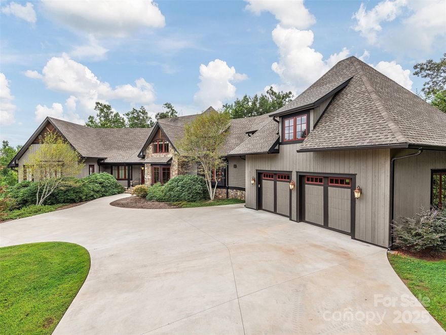 Elegant mountain retreat in the heart of Lake Adger offers year-round mountain views and luxurious comfort. Features a welcoming great room with 21-foot-tall ceilings and a stacked stone fireplace creating a warm and inviting atmosphere for gathering and relaxation. Culinary enthusiasts will love the spacious gourmet kitchen, thoughtfully appointed throughout and ideal for both everyday meals and entertaining. The expansive primary ensuite is a peaceful retreat and features a private sitting parlor. There is an outdoor screened living room to enjoy fresh air and mountain vistas. Guests are accommodated in two comfortable suites, while the lower level boasts a family room with wet bar and versatile bonus rooms. Also includes an oversized two-car garage plus an over 1100ft2 heated and cooled basement tandem garage/workshop for hobbyist and car collectors. This mountain retreat combines exquisite design, practical features, and stunning natural surroundings for an exceptional lifestyle.