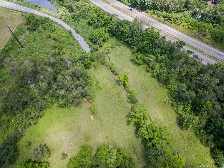 9.4 acres in a thriving commercial area. Deeded paved and curbed right of way through the newly developed Northridge Commons. Lowes, Walmart, Dollar Tree, and other big names share this road and site. New retailers including Hobby Lobby and Marshalls are coming soon, bringing more vehicle and foot traffic to the area. Property would be perfect for multi-family or commercial development. Interstate frontage, city water and sewer and easy laying land makes this a great piece! Also listed in MLS # 3478002.