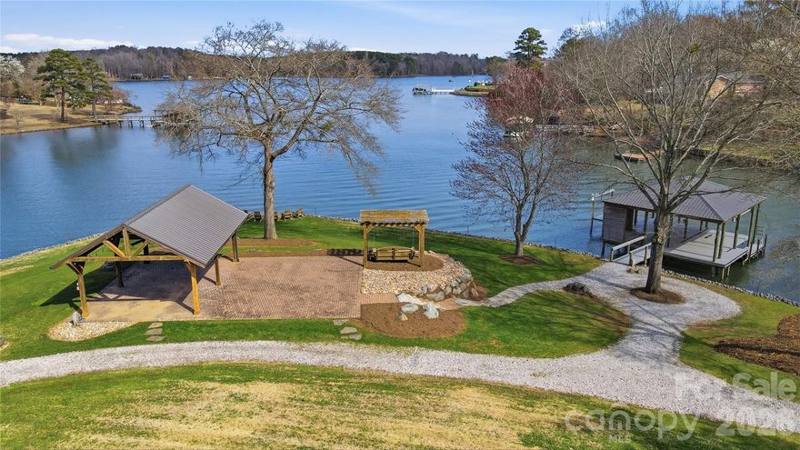 Prepare to be amazed by the breathtaking, long-range views of Lake Wylie from this stunning waterfront property. This rare 4.93-acre homesite offers the perfect opportunity to build the forever home of your dreams while enjoying the serenity and beauty of lakefront living today. The gently sloping landscape provides easy access to the lake while maintaining exceptional privacy, surrounded by beautiful mature hardwoods and approximately 549 feet of shoreline. Outdoor features already in place include a well, private driveway, storage shed, spacious covered pavilion, and stabilized shoreline. There is even an  amazing covered dock with seating area, boat lift, and jet ski lift ready to start your boating adventures.  Additional highlights include South Carolina taxes and access to the highly regarded Clover School District. This one-of-a-kind property combines space, privacy, and spectacular views, making it the perfect place to create the ultimate waterfront estate.