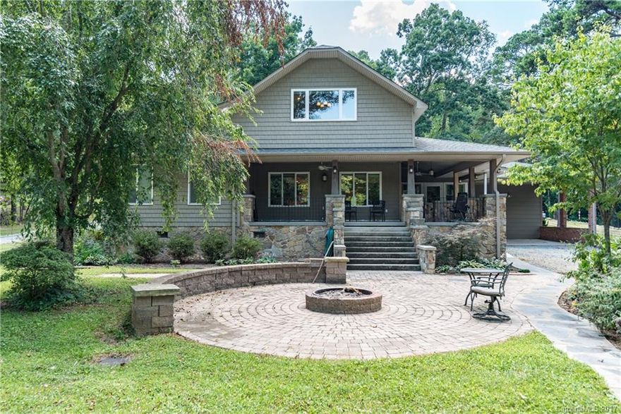 REDUCED- Your own private waterfront living on Mountain Island Lake. Kitchen w/granite countertops, cherry cabinets, oak flooring & stainless steel appliances.  Home features a cozy den with woodstove, spacious family room, large loft for an office/playroom or workout space.  Great outdoor space with wrap around porch, outdoor firepit, brick paver patio plus an all season room. Home is very convenient to the Riverbend Village that's coming soon. Easy commute to downtown Charlotte or airport.