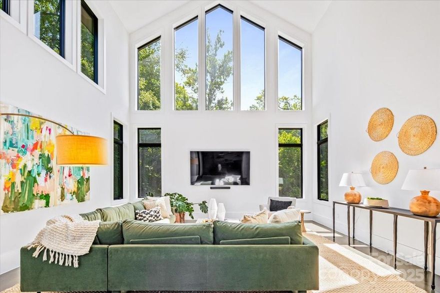 Experience modern living at its finest in this exquisite newer construction home thoughtfully designed, built, and lived in by a local custom builder.  This is your unique opportunity to purchase a spec home custom built with energy efficiency and extraordinary attention to detail and ready for your buyer to make their own decorative selections. Located on an extremely rare wooded 1.65 acre lot in Myers Park (literally minutes from Freedom Park) with private rear views of a neighborhood pond offering abundant bird watching, wildlife viewing and a green scape that is nearly impossible to find in the area. 
The home features 5 bedrooms and 3.5 baths, with three of the bedrooms being located on the main floor.  Enter into a grand open living area with 25 foot ceilings in the great room.  The great room is lined with windows to view the beautiful treescape and flows into dining and a spacious cooks kitchen with modern black cabinetry, center island with prep sink, and top of the line appliances. An expansive covered porch is accessed through modern french doors just off the dining area and is set up for an outdoor kitchen. There are multiple flex spaces throughout with a sunny sitting room at the entry, as well as a room perfect for home office, workout or hobby space, and an upper level loft which offers an abundant open bonus space. A main level primary suite features vaulted ceiling, two walk in closets and an ensuite with modern floating vanity, walk in shower with operable skylight, and access to the outdoor shower. 
Delight in all of the architectural details such as coveted cathedral ceilings with floor to ceiling windows, an open steel and wood tread staircase, concrete flooring, floating vanities, lofts in both upper level bedrooms and much more. The rear of the home allows for a private pool and spa area.  The ultimate privacy and a must see in the heart of Myers Park. Conveniently located minutes from Uptown, Freedom Park, Dilworth, airport, and major interstates.
This home offers terrific suggestions for final design touches in an Idea Book which can be found in the attachments.