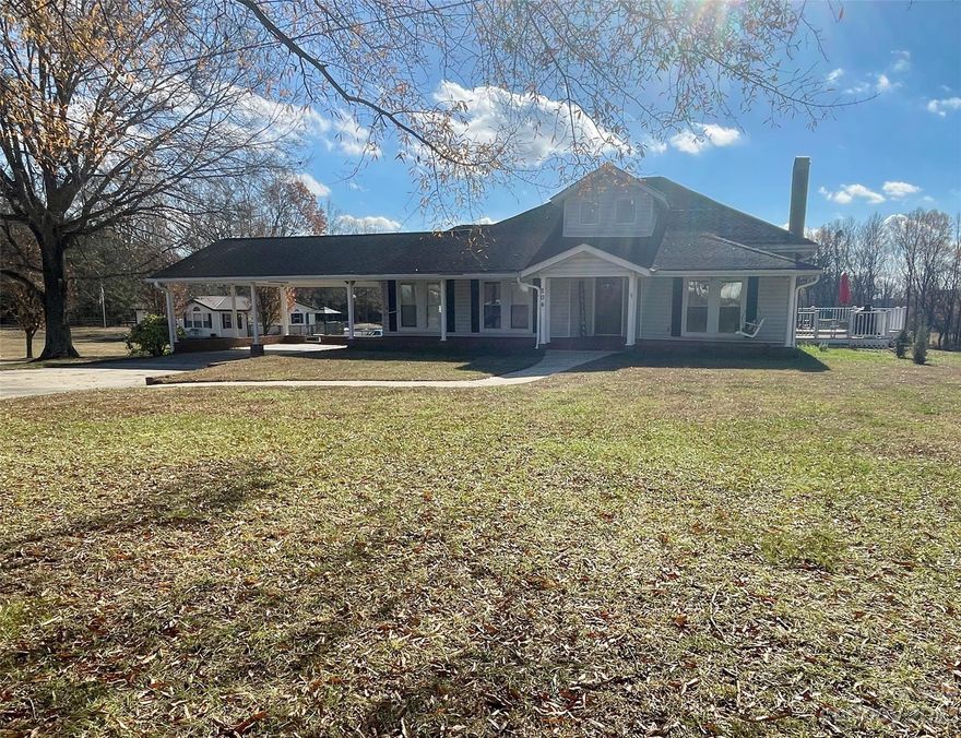 SELLER TO PAY $2000 OF BUYER CLOSING COSTS!  Welcome home to this charming 3 bed, 2 bath farmhouse with an inviting rocking chair front porch and swing.  Enjoy ample parking with an attached double carport and a long, wide concrete driveway.  Additional perks include a detached wired garage/workshop, cozy electric fireplaces, hardwoods in some areas, and a spacious deck for entertaining.  Located in Cherryville ETJ with city water and Duke power, this home is within walking distance of shopping, medical, hardware, food places, and only 1.5 miles from town.  Blink camera system, refrigerator, washer, dryer will convey. HVAC was replaced in 2019.  Schedule your showing today!