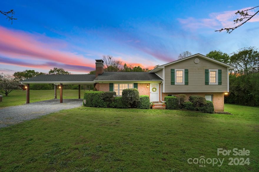 Charming home on 3.91 acres boasting lush fruit trees and a strawberry patch. Step onto the covered patio spanning 440 sq ft with a perennial flower bed out behind the patio, perfect for outdoor relaxation. Enjoy recent upgrades including grading, landscaping with drains (2019), and motion-sensor lighting around the perimeter (2018). Hardwood floors throughout with tile bathroom floors, the cozy living room features a custom fireplace rebuilt in 2018 with Emberstone Chimney, Granite kitchen bar, dishwasher 2022 and lighting under the cabinets in 2018. Discover the unfinished basement with a custom-built workshop, air filtration unit, and complete filtration system professionally installed. Additional upgrades include blown attic insulation, 200 amp electrical (2017), well pump replacement (2017), upgraded well fittings (2022), enclosed crawl space (2017),  carport (2019), gutters/leaf filtering 2018/2019. 
 Don't miss the opportunity to call this meticulously maintained property home!