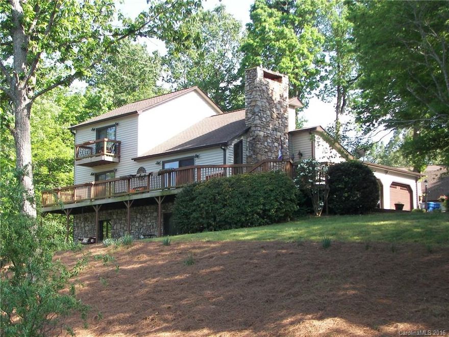 Unique rustic home tucked in 3+acres at the end of a private drive that overlooks a serene lake w/ dock. Take a dip in the heated $30,000 gunite pool or fish off of your private dock! Lower level has a newly tiled rec room/den and tons of storage. Master has huge walk in closet and private balcony. Recent $24,000 new vinyl siding. Add. storage available in the 2story detached garage that has plumbing and electric! This home has so much to offer! Just minutes away from the booming Hwy 150 & 16!