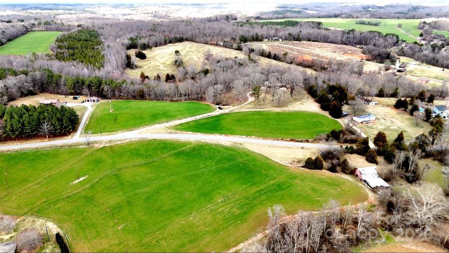 Discover the beauty and potential of this 90+ acre farm, offering a perfect mix of rolling hills, valleys and open fields.  With road frontage on both Little Mountain and Joe Johnson Roads this property provides easy access and multiple entry points, making it ideal for various agricultural and recreational uses.  The land features two pastures perfect for livestock as well as expansive open fields suitable for crops or hay.  2 streams wind through the property, adding to its charm and providing a natural water source.  The well built 3 bedroom, 2 bath farmhouse with a full unfinished walkout basement if ready for the new owners touches.  With its versatile acreage, stunning landscape and convenient access this farm is a rare opportunity for those seeking a working property, a rural retreat or a future homestead.  Don't miss this chance to own this beautiful piece of countryside with no restrictions.