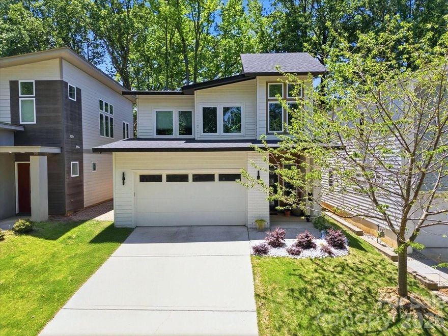 Welcome to this thoughtfully designed contemporary home with no HOA, ideally located just minutes from Plaza Midwood, Ovens Auditorium, Bojangles Coliseum, trolley access, and a quick commute into Uptown via Hwy 74. Offering the perfect blend of modern design, functionality, and energy efficiency, this 3-bedroom, 2.5-bath home combines comfort with smart living.

Inside, you’ll find an open and airy floor plan with 10’ ceilings on the main level, creating a spacious feel throughout. The kitchen and living areas were designed for both everyday living and entertaining, while the oversized primary suite features a spa-inspired walk-in shower with a rain head.

Built with efficiency and technology in mind, the home includes Ecobee smart thermostats with room sensors for customized comfort, whole-home water filtration, Martin Logan in-ceiling surround speakers, motorized stairwell blinds, blackout blinds in all bedrooms, and EV-ready electrical capacity with room for a 60A connection.

Outdoor spaces are equally inviting with a covered rear patio and shaded backyard ideal for relaxing or entertaining, along with beautifully maintained landscaping featuring Zoysia grass in the front yard and tall fescue in the rear. The oversized, fully finished two-car garage offers additional depth and width beyond a standard garage, creating exceptional flexibility for storage, workshop space, a home gym, or oversized vehicles while still comfortably accommodating everyday parking.

A rare combination of modern style, smart-home functionality, and in-town convenience in one of Charlotte’s most accessible locations.