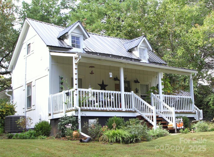 Delightful Tryon Cottage – Walk to Downtown! Nestled in a quiet, private setting just a short stroll from downtown Tryon, this charming two-bedroom, two-bath home blends classic character with thoughtful modern updates. The home has a historical record of short-term rental success and is equally suited as a full-time residence or weekend retreat. Luxury vinyl plank (LVP) flooring was installed throughout in 2024, replacing the original hardwoods, and a wood-burning stove in the dining room (added in 2023) provides cozy warmth and ambiance. Modern upgrades—including a new metal roof, HVAC, plumbing, electrical, and renovated bathrooms—ensure lasting comfort and peace of mind. Enjoy the wide covered front porch with a swing and the tranquil setting, or take advantage of the new 10x16 portable storage building added in 2025 for extra workspace or garden storage. Another exciting feature is the home’s prime location adjacent to the soon-to-be-established Rails-to-Trails pathway—a unique advantage that promises to enhance both lifestyle and property value. Two rooms feature lower ceiling heights (approximately 6’7”) that could be raised if desired. This century-old Tryon treasure is move-in ready and waiting to welcome its next owner. Please Note: Per NCREC guidelines, portions of the home have ceiling heights below 7 feet, including the bathrooms, laundry area, and portions of the second floor. These areas are noted on the floor plan and in the MLS as "Low Ceilings." The second-floor space is included in the total HLA with this disclosure.