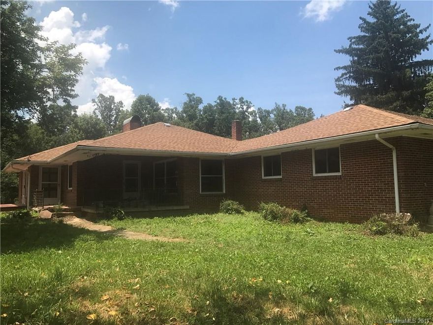 Hard to find horse property complete w/2 barns & other structures. Main barn boasts a whopping 2500 sq ft, w/ 8 stalls,  tack room & hayloft! The sprawling brick rancher is perfectly situated on gentle pasture land. Home appears solid & is waiting to be rehabbed. The sellers have begun the process. Pick up where they left off & create a showplace to suit your tastes. The bones are there w/ huge living spaces. Pastoral & mountain views! Private & only 15 min to Asheville. 2 streams on property!