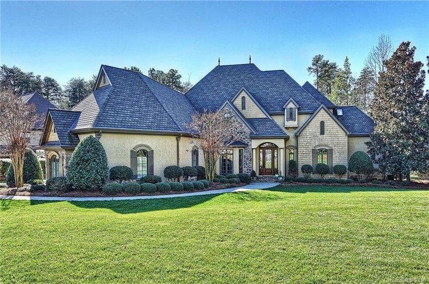 A sprawling estate with PRIVATE BEACH, deeded boat slip & lift on the lake! This gorgeous 4BR 4.5 bath home will take your breath away with pristine grounds, 4,964 luxurious SF & priceless water views. A double-height entry hall & grand living/entertaining spaces feature beautiful columns, open doorways, exquisite millwork & built-ins. The incredible chef’s kitchen & glamorous master suite are beyond compare. A bonus room & home office/BR open to a tranquil terrace with picture postcard views.