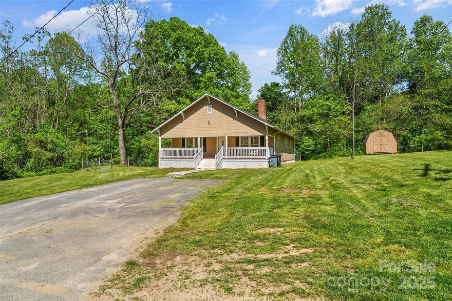 Enjoy peaceful living on 2.38  acres. This home featuring 2 bedrooms and a flexible bonus room—perfect as a third bedroom, office, or guest space. The spacious family room includes a cozy fireplace, and the layout offers a formal dining area and large kitchen. The home features a newer roof and HVAC system, along with both well and county water. A creek runs along the property, with open pastureland that can be fenced—ideal for a mini farm or garden. An outdoor building provides extra storage or workspace. Relax on the front porch swing with views of the stream. Conveniently located just half a mile from I-40 for easy access to town and no city taxes.