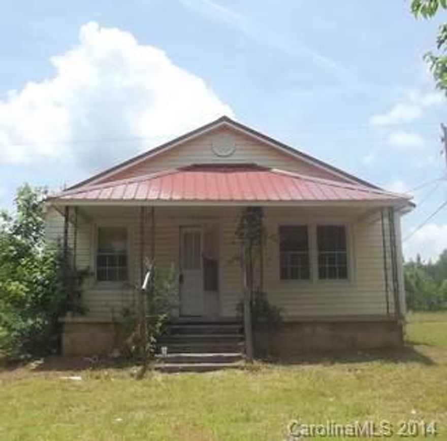 Age is approximate. Home has some exterior improvements such as a metal roof, vinyl siding and replacement windows. The interior needs extensive renovation.