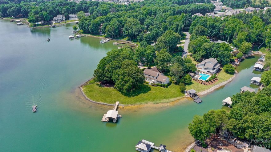 Experience waterfront luxury in this unique custom-built home sitting on a cul-de-sac flat nearly-acre lot graced with over~300 Ft of beach-like shoreline w/ incredible Views! This home has over 4000 sqft of living space, 4 BDRMS, 3.5 baths, & 3-car garage! The primary suite on the main level, offers an oasis of space w/ giant walk-in closet & bath! The open-concept design blends form & function, adorned w/ Oak hardwoods, custom built-ins, a fireplace, and a chic wet bar. The gourmet kitchen, recently updated, w/ granite counter, S/S appliances, seamlessly integrates w/ the surrounding spaces. The 2nd floor, reached via two staircases, resides 3 BDRMS, two full baths, an office, & huge bonus room! The property offers a unique opportunity to finish an additional 750+ sqft of space! The back deck runs the entire length of the home, perfect for outdoor entertainment w/ a picturesque backdrop of the flat lot meeting the lake. A covered boat dock & full irrigation system is present! No HOA!