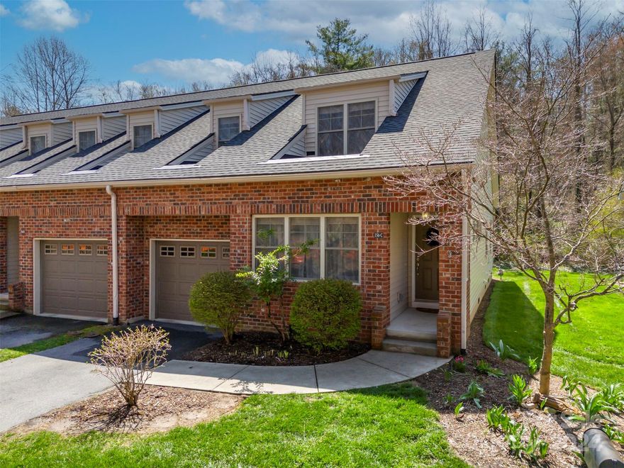 Welcome to effortless townhouse living in this charming 1.5-story unit boasting an airy open floor plan. As you enter, you're greeted by a spacious living room with a vaulted ceiling, a cozy gas log fireplace, and abundant natural light. Adjacent to the living room, the dining area seamlessly flows into the kitchen. Step outside onto the partially covered deck and soak in the peaceful ambiance of the backyard, bordered by Wash Creek and a bird sanctuary. Retreat to the main-level primary suite, where luxury awaits with a Bluetooth-enabled walk-in tub/shower and a walk-in closet. Upstairs, discover a versatile layout featuring a bedroom, a bath, and a loft bedroom—perfect for accommodating guests, multigenerational needs, or setting up a home office. It's a prime location on the border of Laurel Park and is 1 mile from downtown Hendersonville, an easy drive to Jump Of Rock and Flat Rock. With the upcoming Ecusta Trail steps away, outdoor adventures are never far away!