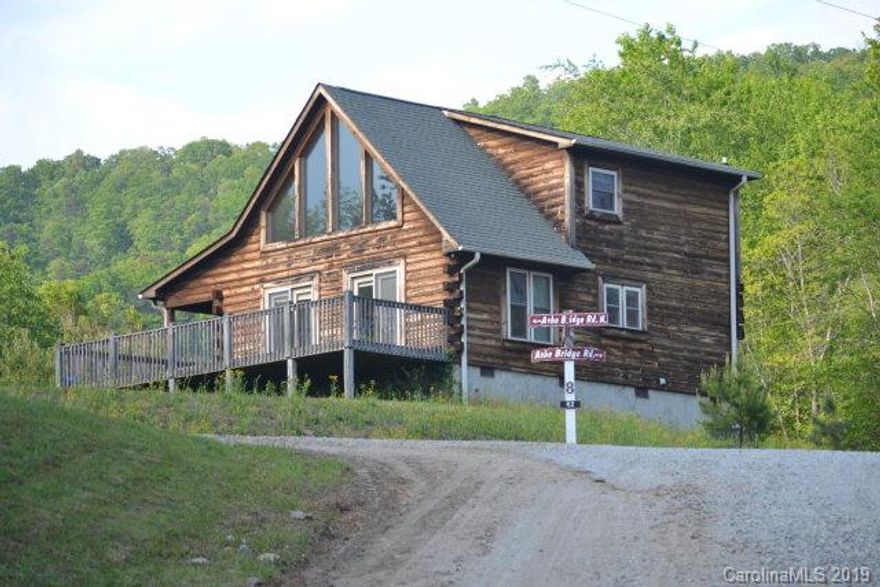 This Log home is waiting on you to come and sit on the wrap around porch in your rocker and watch the turkeys walk past.  Its main level features gas fireplace,  living room with siding glass doors, and dining area just off the kitchen. One of its bedrooms with attached bathroom and Laundry room is also on this level.  Its upper level has a LOFT that features a bedroom, bathroom and additional living space that could be used as an office/study/bonus area. Don't miss out on this great deal! Act now and call today.