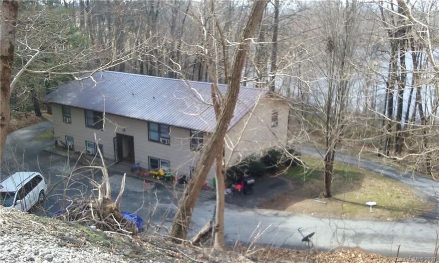 LAKE VISTA APARTMENTS, overlooking very large water view, perfect serenity ... only a mile from Historic Downtown Hendersonville, walk to shops and eats.  Enjoy a private resort like entrance, beautiful grounds, each apt. has a private deck or patio.  TOTAL of 8 two bedroom and one bath units, cash cow, very low maintenance ... you do the math what would you rent these one-of-a kind homes for ... how about VRBO, WOW! Condition is shuffy, polish up and add your charm or just simply MAKE MONEY.