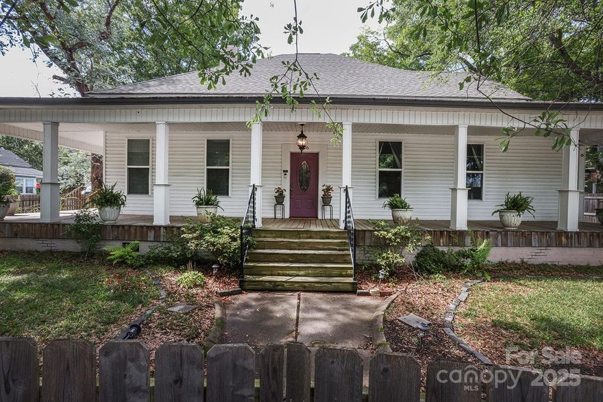 Historic 4 bed 2 bath ranch in the heart of Lancaster. Soaring ceilings and modern updates meets historic charm blending comfortable living with rich character. Double front gate with lush landscape and mature trees provides a sense of privacy. Walking distance to many of downtown's restaurants and shops. Expansive wrap-around front porch is perfect for enjoying the southern climate. Owner's suite has a fireplace, ceiling fan and updated private bath with dual vanity mirrors, walk-in closet and shower/tub. Three additional sizable bedrooms and large full hall bath complete the home. Eat-in Kitchen has been updated with stainless steel appliances. Access to back porch overlooking half acre level property that boasts fruit-bearing trees and bushes with plenty of room for a garden, play and entertaining. Recently painted and well-loved home is less than 30 miles from Charlotte and 50 miles from Columbia. This oasis is a welcome escape from the grind of city life.