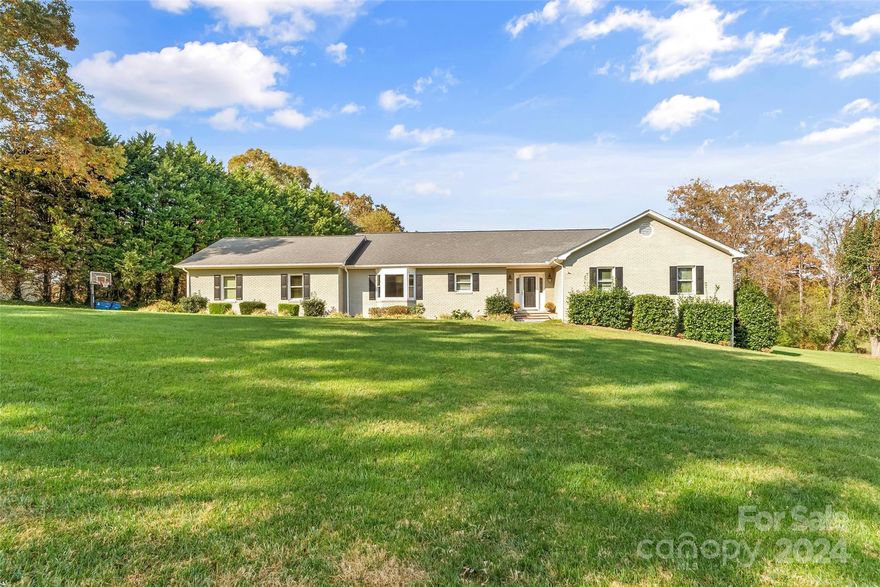 The property at 2110 E Winds is a beautifully updated ranch home featuring a large inground saltwater pool with a diving board and a brick patio area equipped with a retractable awning. The kitchen boasts granite countertops, a tile backsplash, stainless steel appliances, and updated soft-close cabinets. The living room is a standout space, featuring a step-down design and a gas log fireplace. Large doors provide a view of the pool. The home includes a laundry room conveniently located within a half bath. The house offers ample living space with four bedrooms and a spacious primary bedroom. The primary suite comprises a walk-in closet and a well-appointed private bathroom featuring a glass/tile walk-in shower, a dual sink vanity with quartz tops, and a dressing vanity. Additional home features include smooth ceilings, hardwood floors, a partially unfinished basement with exterior access, and an oversized 2-car garage with a storm room. The attached video has been virtually staged.
