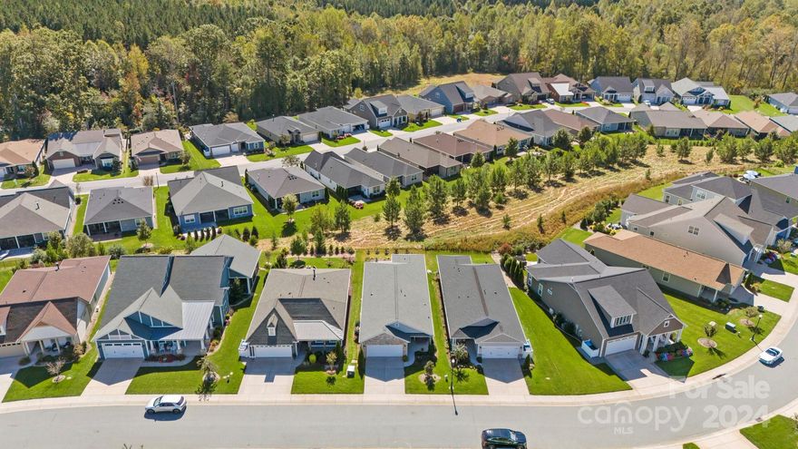 Make yourself comfortable & enjoy the open-concept Glory floorplan that has an amazing use of function & space. Split 2BR, 2B home plus flex space & 2 Car garage with hanging storage rack. Well-appointed kitchen anchors the main living area & includes stainless steel GE Cafe appliances, gas range, solid surface countertops, pendant lighting, light craftsman style cabinetry w/soft close drawers, tile back splash and island breakfast bar. Great room with wall of glass featuring electric privacy shades that open to a screened lanai and extended paver patio for additional entertaining options (plumbed w/gas line) & unobstructed long range views. A serene master suite completes this home & ensuite bath with dual sink vanity, tile floor and a generous walk-in closet & tiled shower. Low maintenance wood and tile flooring (bedrooms carpet) Large laundry room with additional storage. Trilogy Membership includes Freedom Boat Club on Lake Norman plus award winning amenities.