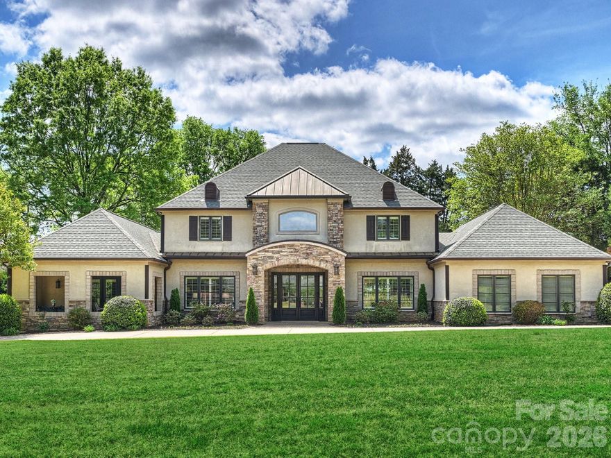 Welcome to this stunning and elegant estate, perfectly situated on .7 acres along the 2nd hole of Carmel Country Club’s north course, just steps from the clubhouse. This beautiful 6-bedroom home with 5 full and 2 half baths offers a warm, inviting, and practical layout. Step into the two-story foyer with its graceful, curved staircase, leading to a spectacular great room featuring reclaimed beams, an oversized limestone fireplace, and beautiful, expansive windows with backyard views. The large, updated chef’s kitchen boasts custom cabinetry, professional-grade appliances, and a spacious island, flowing into a charming breakfast room with a built-in window seat, custom shelving, and pool views. The dining room showcases built-in glass-front cabinetry for display. The den/media/office/playroom is a cozy retreat with its own gas fireplace. The kitchen, dining room, great room, living room, and multi-purpose room connect with high ceilings and an open floor plan. The main level primary suite is very spacious, occupying its own private wing, with a beamed cathedral ceiling, two custom closets, an updated bath, and patio doors to a 235 sq. ft. loggia for morning coffee or afternoon relaxation. There is plenty of room to have a sitting area within the primary bedroom. A guest suite with a private bath sits on the opposite main-floor wing, great for in-laws, guests, or a nanny. Upstairs, four generously sized bedrooms are featured, each with its own bath. Practical areas are a main-level laundry room with an unusually large amount of storage, a custom drop zone with many built-in cabinets and desk, two attic spaces, and an extra-deep and wide two-car garage. High ceilings, heavy moldings, arched casings, solid doors, plantation shutters, and fresh updates add charm throughout. Outdoor living shines with a heated saltwater pool and spa and a 385 sq. ft. pool cabana house with gas fireplace and vaulted ceilings. If a member of Carmel Country Club, the back gate is a quick and easy access to the clubhouse. Not a member, the yard is private, quiet, and enjoyable and the back yard is great for entertaining family and friends!