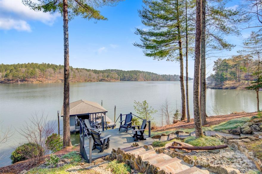 Welcome to Harbor Ridge on serene Lake Rhodhiss where this waterfront home offers lake views from every room in the house. This ranch style 3br 3ba home features an open floor plan showcasing tongue & groove & beam ceilings, oak wood floors, handcrafted solid pecan kitchen cabinets, walk-in pantry and picture windows throughout to view the 366 ft of lakefront property. The primary bdrm located on the main floor features a picture window that jets out from the room giving you a panoramic view perfect for a work desk/chair grouping to take in the sights. The 2nd bdrm, split plan from the primary, has views of its own featuring double doors that lead out onto the back deck. The 3rd bdrm located downstairs, has its own private balcony with the same panoramic views. The home also features stunning landscaping, slate & stone walkways around the entire home and down to the boat dock, which has power & water running to it and a boat lift. Only 4 min to UNC/Blue Rdg Hospital, fire, post office.