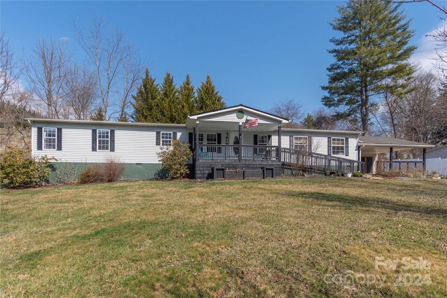 Wonderfully maintained home on approx. .49 gently sloping acres in the Clyde area of Haywood Co. This 3 BR, 2 Bath home includes an office/ bonus room plus a formal dining area along with a large living room, Granite Counter tops in kitchen, New Metal roof in 2023, 8 x 13.5 Screened Porch on end of home, Double Sink in main Bath, electric fireplace in LR, 2 car attached carport, 10x16 Workshop attached to carport, mature landscaping. All appliances convey, washer/dryer 3 yrs old. Nice front yard with  ornamental trees. Ornamental water feature in back yard!