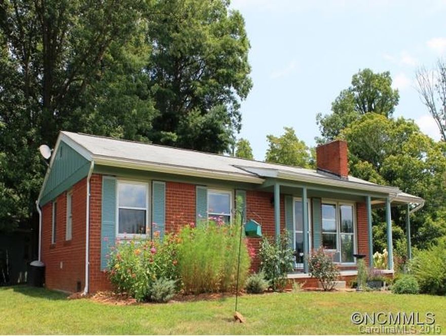 Year round long range mountain views from this one level cottage with 975 +/- square feet, two bedrooms, one bath, 1.72 +/- acres, hardwood flooring, bonus room with closet, single attached carport, detached workshop with electricity, beautiful landscaping,paved driveway, convenient location to downtown Asheville.