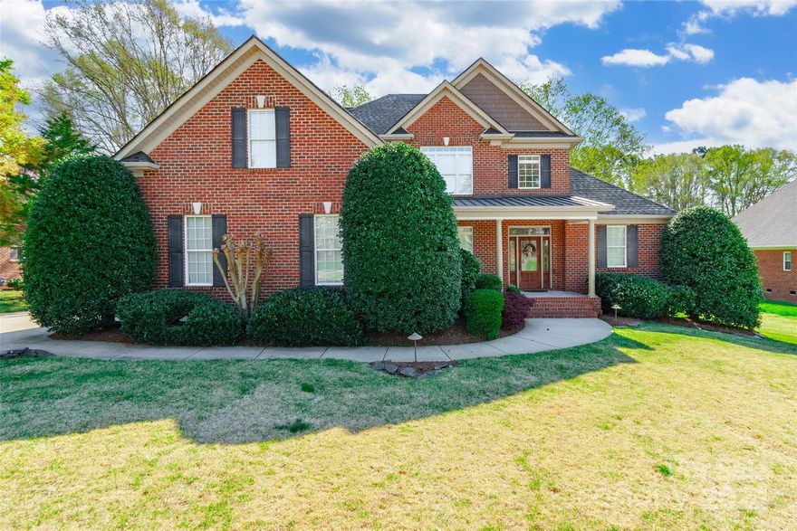 Experience sheer elegance from the moment you arrive at this all brick 5 bedroom, 3.5 bathroom home, boasting a covered front porch that sets the tone for what lies within. Hardwood floors adorn the main living areas, complementing the open floor plan that leads seamlessly to a great room w/gas log fireplace. The kitchen is a chef's delight, featuring granite countertops, a breakfast bar, pantry, and stone flooring. The large primary bedroom on the main floor offers new carpet, tray ceilings, bay windows, and an ensuite bathroom with dual sinks and a garden tub. A 2nd fireplace graces the living room on the main floor, while the remaining bedrooms are conveniently located on the 2nd floor. Outside, enjoy the spacious deck that overlooks a beautiful fenced backyard. Additional amenities include a separate garage entrance, irrigation system, and stunning landscaping. Don't miss the opportunity to call this exquisite property your home!