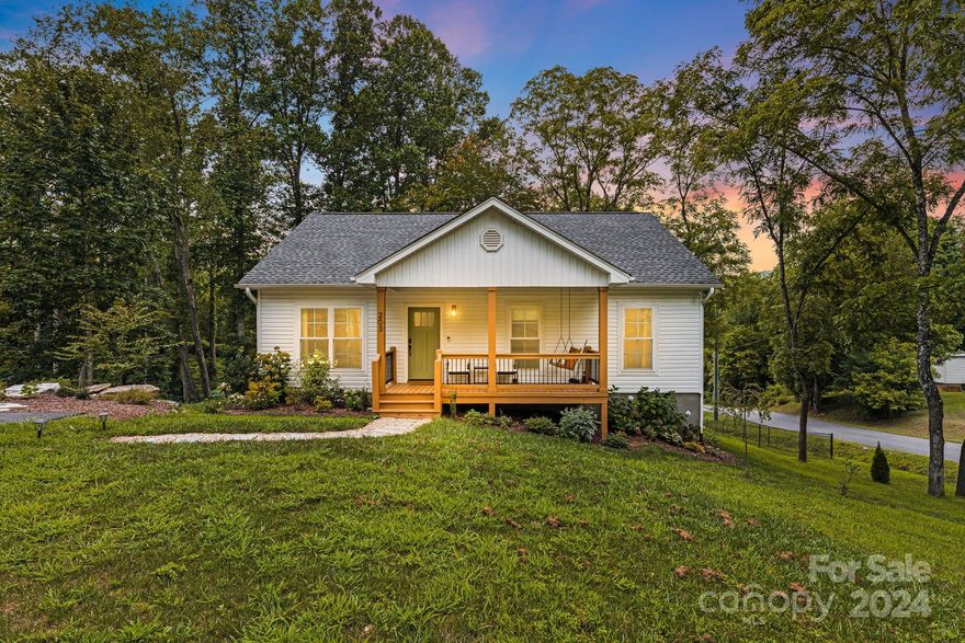 Back on Market due to no fault of sellers. Schedule a showing today! Welcome home to charming single-story living, ideally situated for those who appreciate nature while enjoying easy highway access. This home has an elegant boho feel, thoughtfully designed by the owners in 2022 when the home was built. The primary suite includes a generous walk-in closet with custom shelving and its own private bathroom. With a separate laundry room/pantry and two more bedrooms, the space is allocated with efficiency in mind. Step outside onto the spacious deck to take a peek at the mountains and overlook the large fenced in yard. Walk up the side of the home to see the raised garden beds or sit by the peaceful little pond in your new front yard! The location is ~15 minutes to downtown Asheville & ~30 minutes to Hendersonville. Truly a rare find!