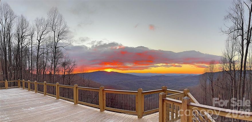 There’s something about the mountains that makes you slow down… and the moment you pull into the drive, you feel it and when we say it's all about location- the location of this home speaks volumes. 

Perched above a rolling valleys with layer after layer of long-range mountain views and vistas, this nearly new home—completed at the end of 2024—was designed to take full advantage of its setting. Whether it’s the soft morning light rising over the ridgelines or the quiet stillness that settles in at sunset, every part of this property invites you to pause, take a breath, and stay awhile.

Step inside and the feeling continues. The main level is warm, open, and welcoming, with a living room centered around a beautiful stone gas fireplace—perfect for cool mountain evenings. The kitchen blends charm and function with granite countertops, a farmhouse sink, and gas range, while the dining area opens to a screened porch where you can enjoy the outdoors without ever leaving your seat.

And then there’s the deck… over 800 square feet of it. This is where mornings begin with coffee (or Diet Coke ??), where conversations stretch a little longer, and where the views become part of your everyday life—wide, layered, and ever-changing with the seasons.

The main floor offers two bedrooms and two full baths, thoughtfully laid out for comfort. Downstairs, the home opens up even more possibilities. With its own entrance—both inside and out—the lower level lives like a completely separate space, featuring a full kitchen, living area, bedroom, and bath. Whether you’re hosting guests, accommodating extended family, or creating a second short-term rental, the flexibility here is a rare and valuable find.

Step outside again and you’ll find just as much intention in the land as in the home itself. Carefully designed landscaping creates a peaceful, park-like setting, complete with a seasonal creek and a custom rock bridge that adds just the right touch of character. It’s quiet here. Private. The kind of place where you can actually hear the breeze move through the trees.

Practical features haven’t been overlooked either, with a whole-house generator, tankless water heater, generous parking, and a large storage space tucked beneath the garage accessible from the downstairs living area—perfect for all the extras that come with mountain living.

And while it feels like a world away, you’re still just minutes from it all—less than a mile to the Blue Ridge Parkway and a short drive to Little Switzerland, with easy access to hiking trails, waterfalls, and some of the most scenic spots Western North Carolina has to offer.

This isn’t just a home—it’s a place to reset, recharge, and reconnect. Whether you’re looking for a private mountain escape, a full-time residence, or an income-producing retreat, this one offers something special… and once you’re here, you’ll understand why.