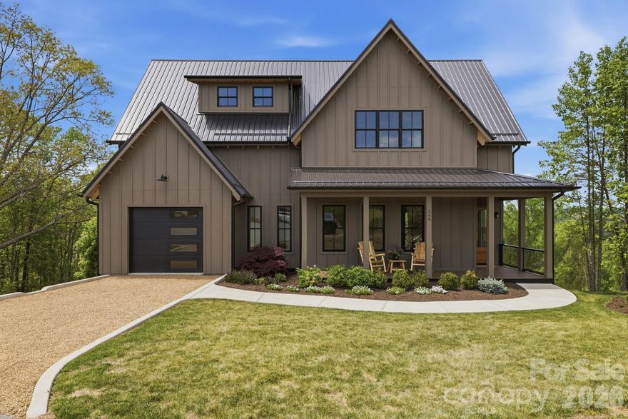 Positioned within the sought-after Olivette community, this modern farmhouse offers a refined blend of contemporary comfort, energy efficiency, and natural beauty. Westridge Farm Rd borders the community’s working organic farm, boasts a stunning community fire pit, and community garden space. Just 15 minutes from Asheville and Weaverville, this home & community strike the rare balance of privacy and convenience.

Built by Ward Enterprises, the home is filled with natural light and designed for effortless living. The open-concept floor plan features soaring cathedral ceilings and seamless indoor-outdoor flow, creating an ideal environment for both everyday living and entertaining. Offering 3 bedrooms and 3 full bathrooms, the home also includes generous additional flex space—perfect for a home office, den, or guest overflow.

The kitchen is thoughtfully appointed with a large island, walk-in pantry, double oven, gas range, pot filler, and ample storage. The fully finished basement adds even more versatility for guests, fitness, work, or recreation. Geothermal heating, advanced framing, spray foam insulation, and fiber optic connectivity further enhance the home’s comfort, efficiency, and modern convenience.

Outdoor living is equally compelling, with a covered front porch, vaulted & covered oversized back porch, & multiple balconies designed to capture stunning western sunsets and long-range Blue Ridge Mountain views. Backing directly to a 16-acre conservation area, the property offers an exceptional sense of privacy and connection to the surrounding landscape.

Olivette is a 411-acre riverfront community centered around a fully operational four-season organic farm, offering a lifestyle unlike any other in the region. Residents enjoy access to walking and hiking trails, orchards, community gardens, pickleball court, a private river island with pavilion and fireplace, a fire circle amphitheater, suspended bridge, labyrinth, dog park, playground, and riverfront park. With direct access to these amenities and a setting that feels both peaceful and inspiring, this home offers more than beautiful construction—it offers a truly distinctive way of living.