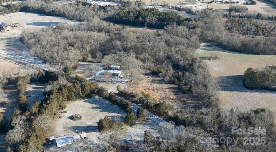 Nestled in a peaceful, private setting just 6 miles from shopping and downtown Rock Hill, this beautiful 10.65-acre property offers the perfect opportunity to build your dream home. With a serene backdrop provided by Stony Fork Stream, this partly cleared parcel is surrounded by mature trees, ensuring both privacy and a natural retreat feel. A
concrete pad for parking is already in place and the well & septic are installed and currently functioning, saving time and money. The existing manufactured home & 2 outbuildings will convey at no value—perfect for storage or temporary use while building your new home. Selling "as is" with no repairs to be done and no showings in the manufactured home until contract accepted.