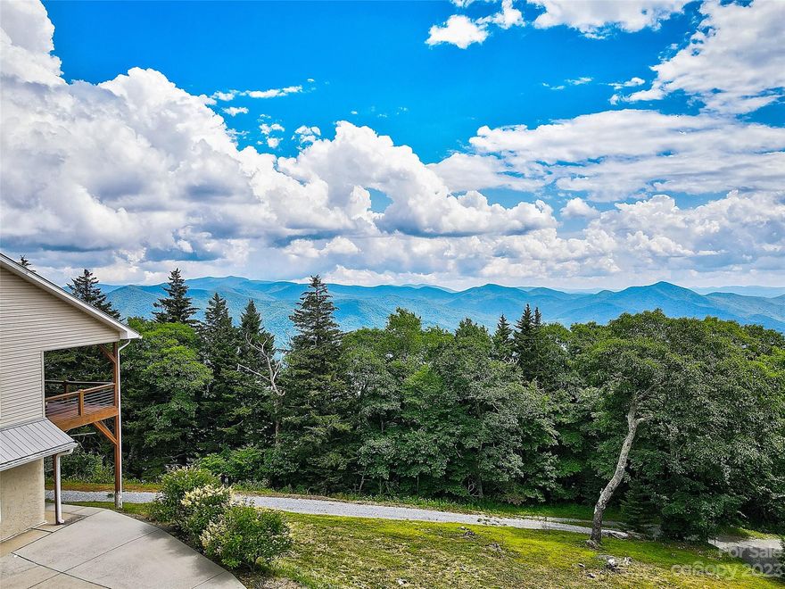 Live above the clouds with year-round mountain vistas! Perched atop Mt. Lyn Lowery at 5500+’ elevation, this 3 bed, 2.5 bath is a rare gem blending luxury with nature's beauty. Upon entering, you'll be captivated by the rich wood tones, maple hardwood floors, 10’ ceilings, & French doors that illuminate the interior, offering abundance of natural light, and scenic views from every angle. The primary luxury ensuite invites relaxation with a soaking tub, walk-in shower, & heated bathroom floor. Convenient stackable washer & dryer in the suite allows for one-level living. The daylight basement has 2 additional bedrooms for guests or extended family with a full bath to ensure privacy. Designed for low maintenance and efficiently built, the home features Superior Walls, central vac, and heated garage and workspace. Outdoor enthusiasts enjoy direct access to Blue Ridge Parkway for hiking and biking trails. Conveniently located between Waynesville and Sylva, this private sanctuary awaits you!